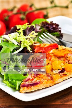 Vegetarian meal of vegetable pizza and green salad