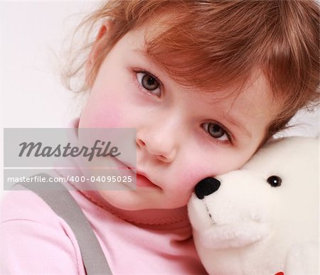 Portrait of sad little girl with teddy