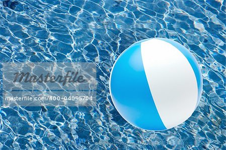 Striped beach ball over the water surface
