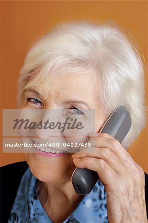 Senior woman smiling with telephone