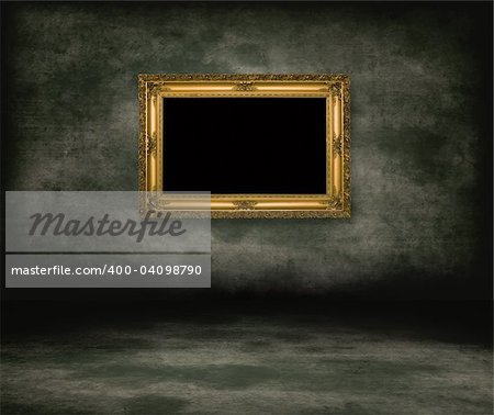 An empty dark dungeon wall. Golden picture frame on wall