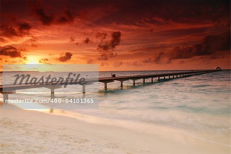 Gorgeous sunset over the sea and a jetty in the tropical paradise of Caribbean
