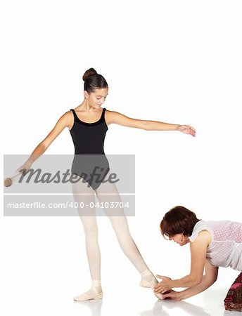 Young caucasian ballerina girl on white background and reflective white floor showing various ballet steps and positions being corrected by teacher. Not Isolated.