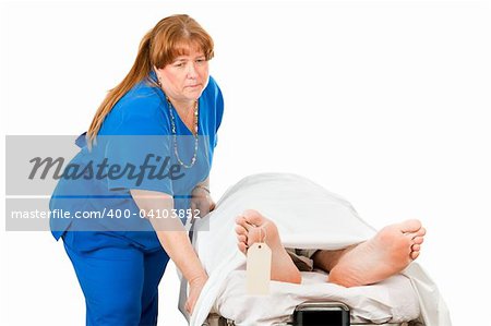 Sad nurse transporting a deceased patient on a hospital gurney.  Isolated on white.