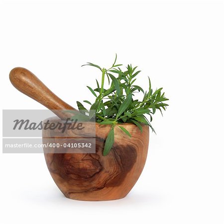 Hyssop herb leaves in an olive wood mortar with pestle over white background.