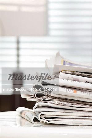 pile of newspapers on the table