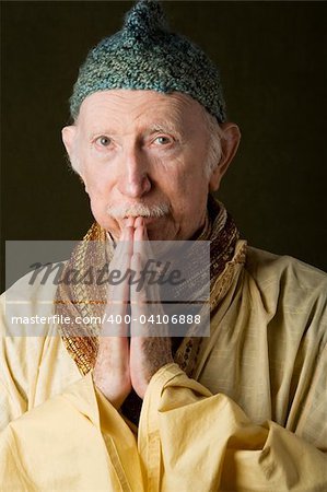Guru praying with hands and looking up