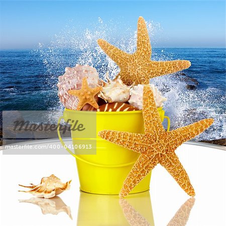 Day Spa Still-life Wtith Starfish And Sea Shells In Colorful Yellow Beach Bucket On White Glass Table