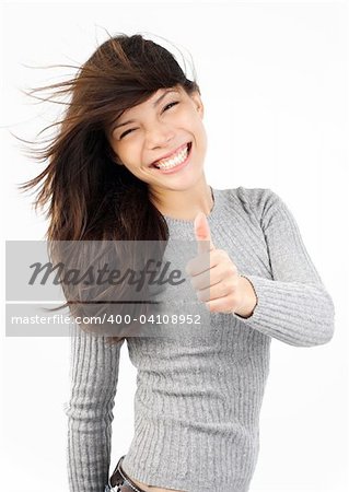 Very excited young mixed caucasian / asian woman giving thumbs up