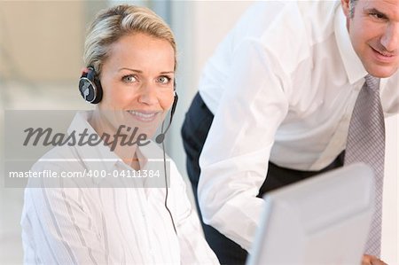 Face of young charming confident woman with headset