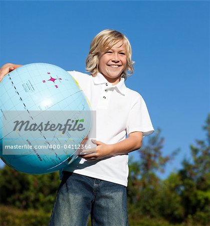 Young Boy holding a Globe in his hands