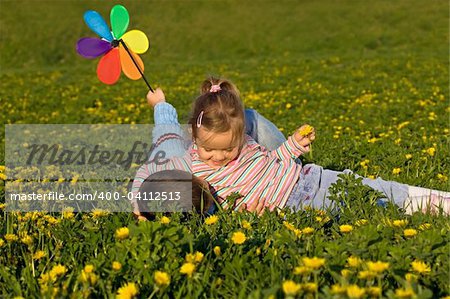 Kids having fun wrestling on the flower field in springtime