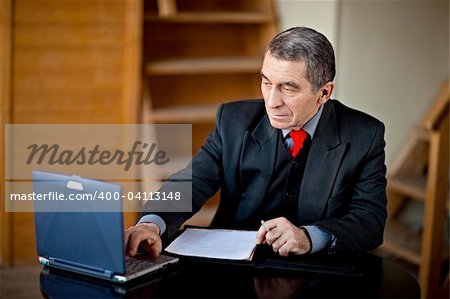 Business man typing and working on laptop computer
