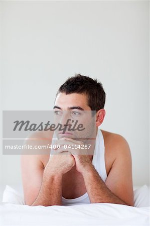 Attractive man lying in his bed