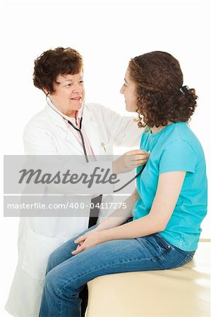 Female doctor examining a teenage girl, listening to her heartbeat with a stethoscope.  Isolated.