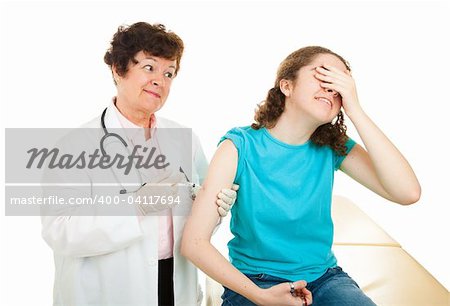 Teen girl afraid and covering her eyes as she gets a vaccination from a doctor.  Isolated.