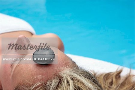 Woman by a blue pool waiting for a a massage