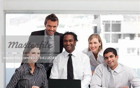 International business team working in an office looking at the camera