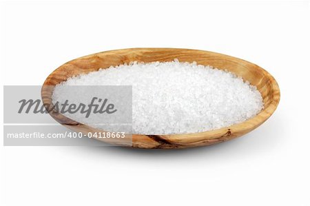 Sea salt in an olive wood oval bowl, over  white background.