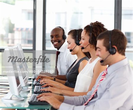Smiling young African-American businessman in a call center