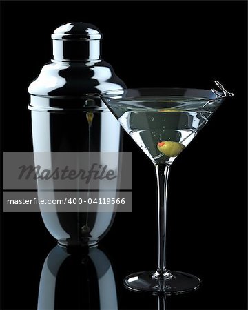 Dramatic, clean shot of martini   with olive, with classic style   steel shaker.