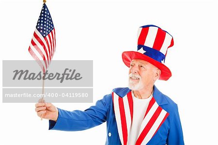 American icon Uncle Sam looks at a US Flag.  Isolated on white.