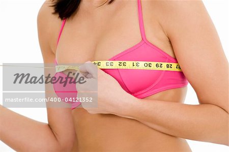 Caucasian woman measuring her bust on a white background