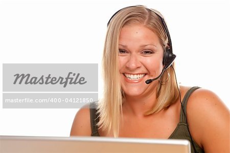 Attractive businesswoman smiles as she talks on her phone headset.