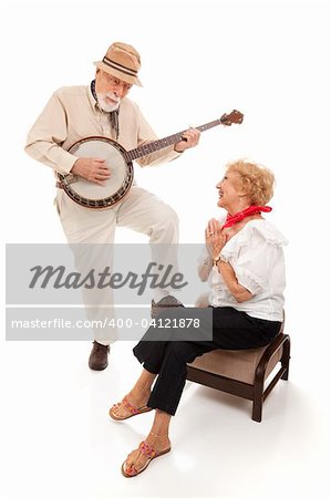 Senior man serenading his lady on his banjo.  Isolated on white.