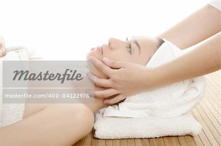 Beautiful woman face massage with towel around her head