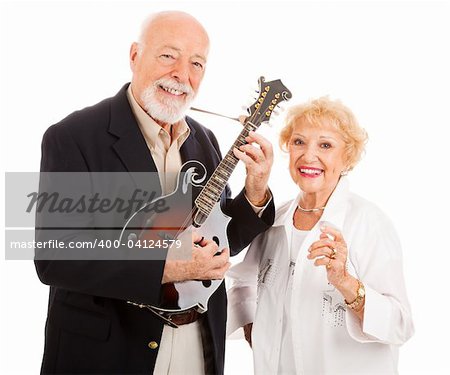 Senior man plays music on his mandolin while his wife sings along.  Isolated