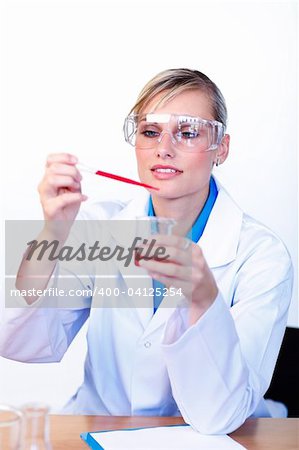 Beautiful young scientist examining a test-tube