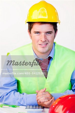 Young man with hard hat looking at the camera