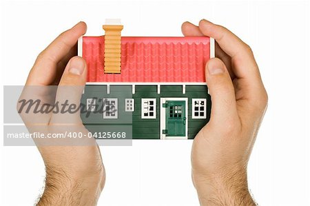 Protective hand holding a modelhouse