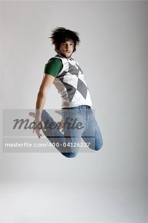Young modern man dancing over a white background
