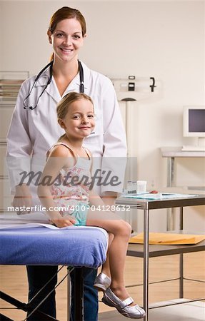 Doctor giving girl checkup in doctorÕs office