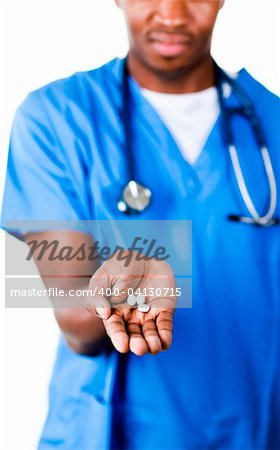 Serious Afro-American doctor holding pills and glass of water in front of the camera