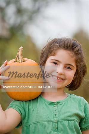 Little Girl Holding a Pumpkin