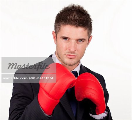 Businessman with boxing gloves on with camera focus on the man