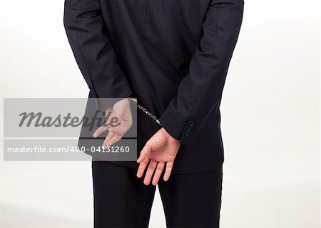 Businessman tied up in hand cuffs