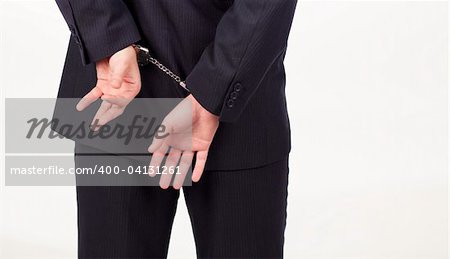 Businessman tied up in hand cuffs