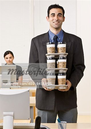 Businessman carrying tray of coffee