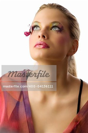 Beautiful blond woman with creative makeup with butterfly on her face looking up