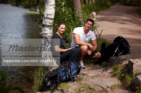 A couple taking a break while on a hiking camping trip