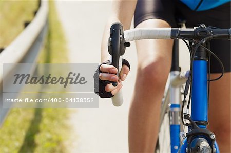 Cropped view of female cyclist with hands on brakes. Copy space