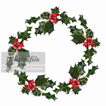 Holly leaf sprigs with red berries forming a circular wreath, over white background.