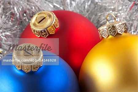 Colorful christmas balls in silver garland background