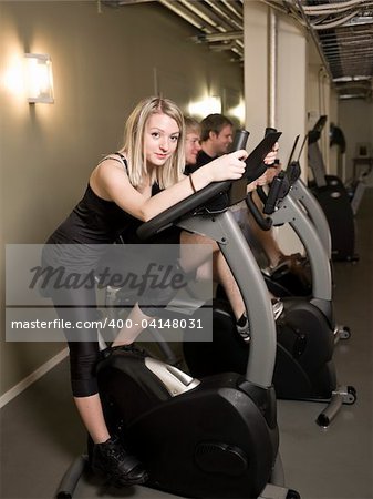 Three people spinning with a girl in focus