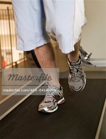 Man running on a treadmill in a healthclub