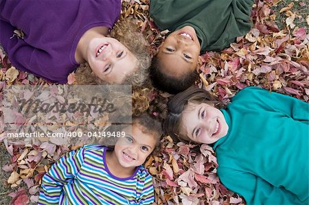 Four Girls Playing in Fall Leaves